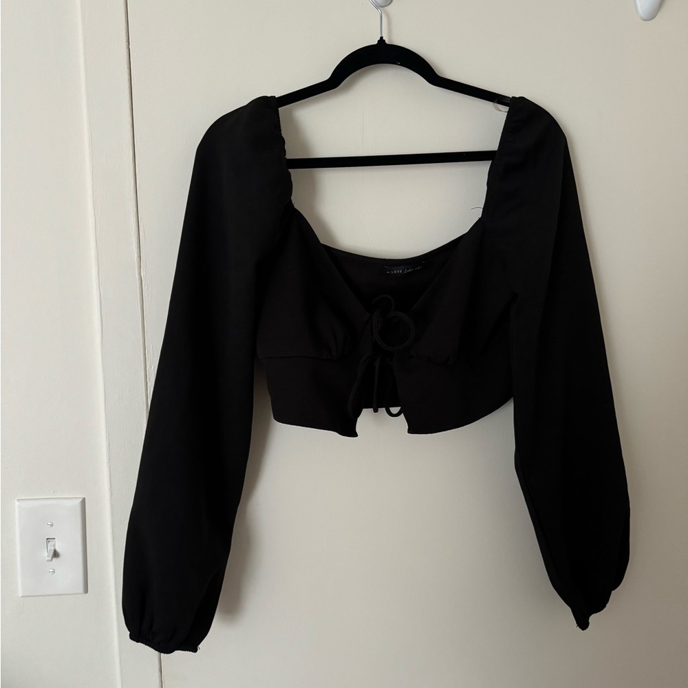 Black long sleeve that has two ties in the front.